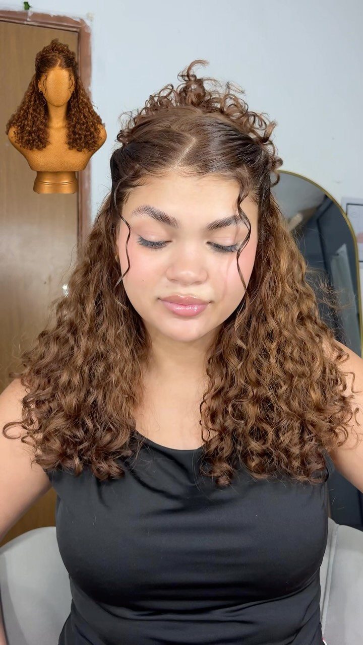 2C Curly Hairstyles: 10 Ideas for Layers, Buns and Bangs 3 Woman with brown curly hair styled in a half-up bun and loose tendrils.