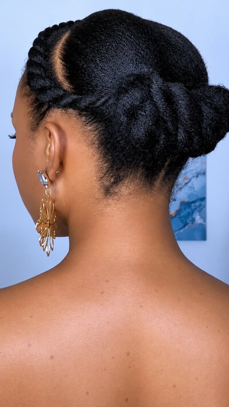 4C Hair Blown Out with Braids, Buns and Waves: 9 Ideas 6 Woman with 4C hair styled in a low bun with twisted sections.