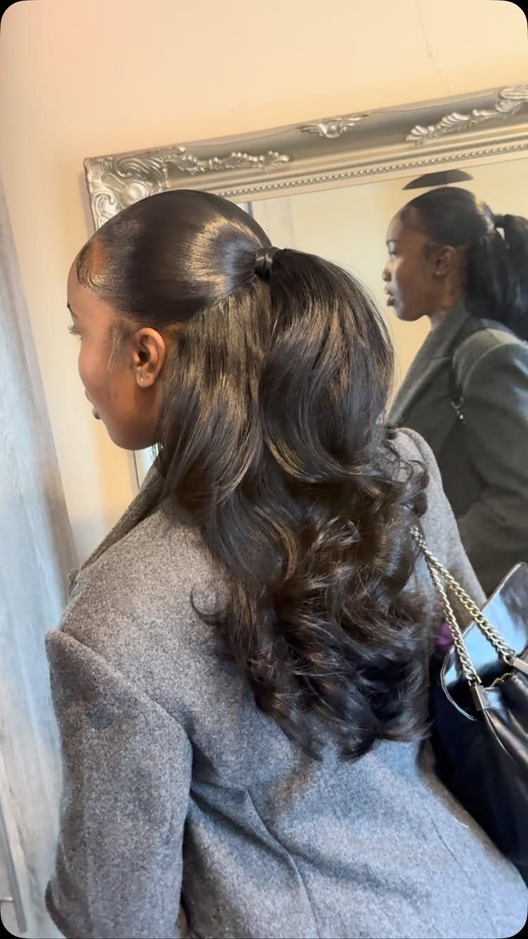 4C Hair Blown Out with Braids, Buns and Waves: 9 Ideas 5 Woman with sleek half-up hair and voluminous wand curls wearing a grey coat.