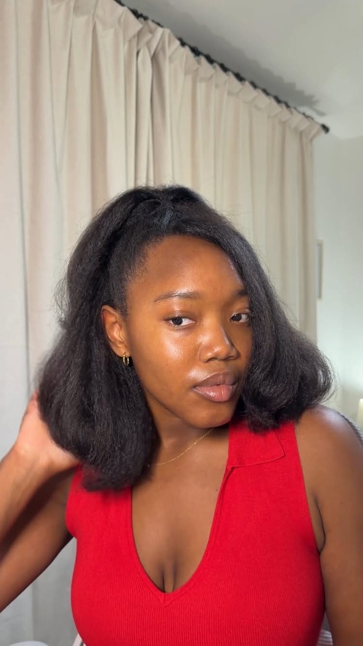 4C Hair Blown Out with Braids, Buns and Waves: 9 Ideas 2 Woman with voluminous 90s style blown-out 4C hair wearing a red top.