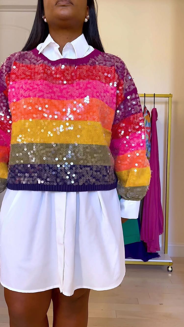 57 Degree Weather Outfit: 19 Ideas to Wear Now 18 Person wearing a colorful sequined striped sweater over a white button-down shirt dress.