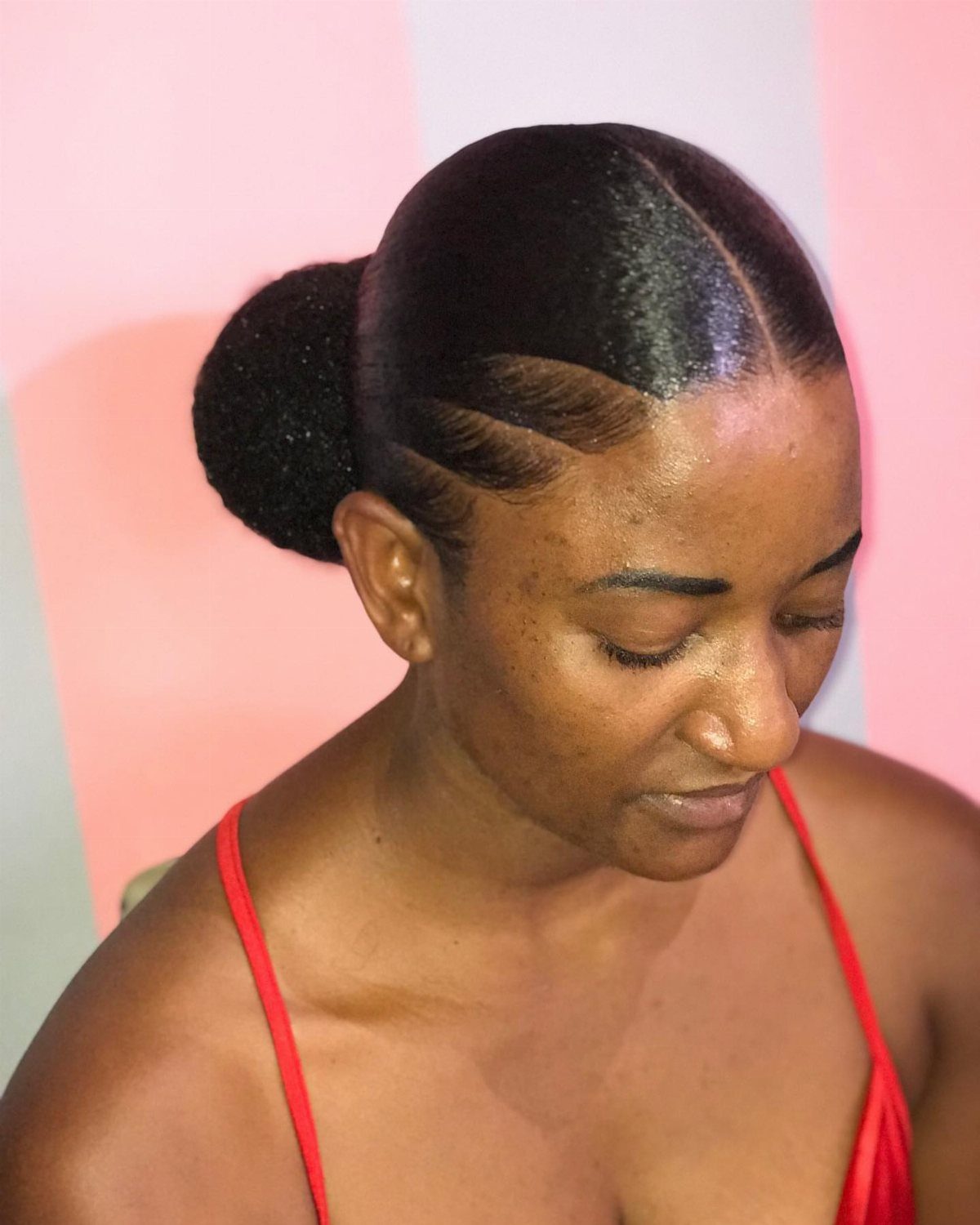 African Hair Lines: 10 Cornrow and Braid Styles to Wear 10 Woman with curved cornrow hair lines gathered into a low bun.