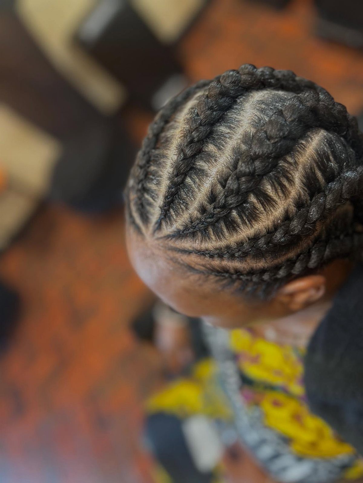 African Hair Lines: 10 Cornrow and Braid Styles to Wear 4 Cornrow braids styled in curved lines across a person's scalp from above.