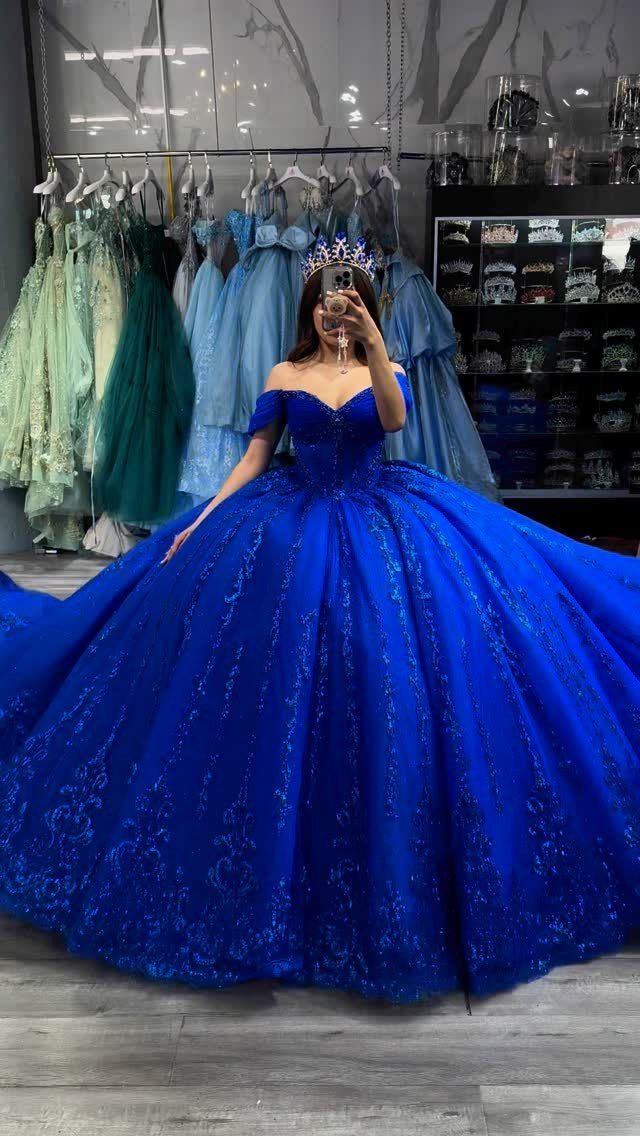 Ball Dresses Blue for Prom and Formal Events: 10 Ideas 7 Woman in a royal blue ball gown with a tiara in a boutique.