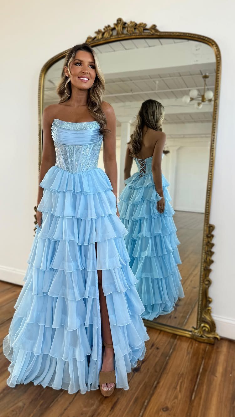 Ball Dresses Blue for Prom and Formal Events: 10 Ideas 5 Woman in a light blue organza dress with ruched bodice and layered skirt.