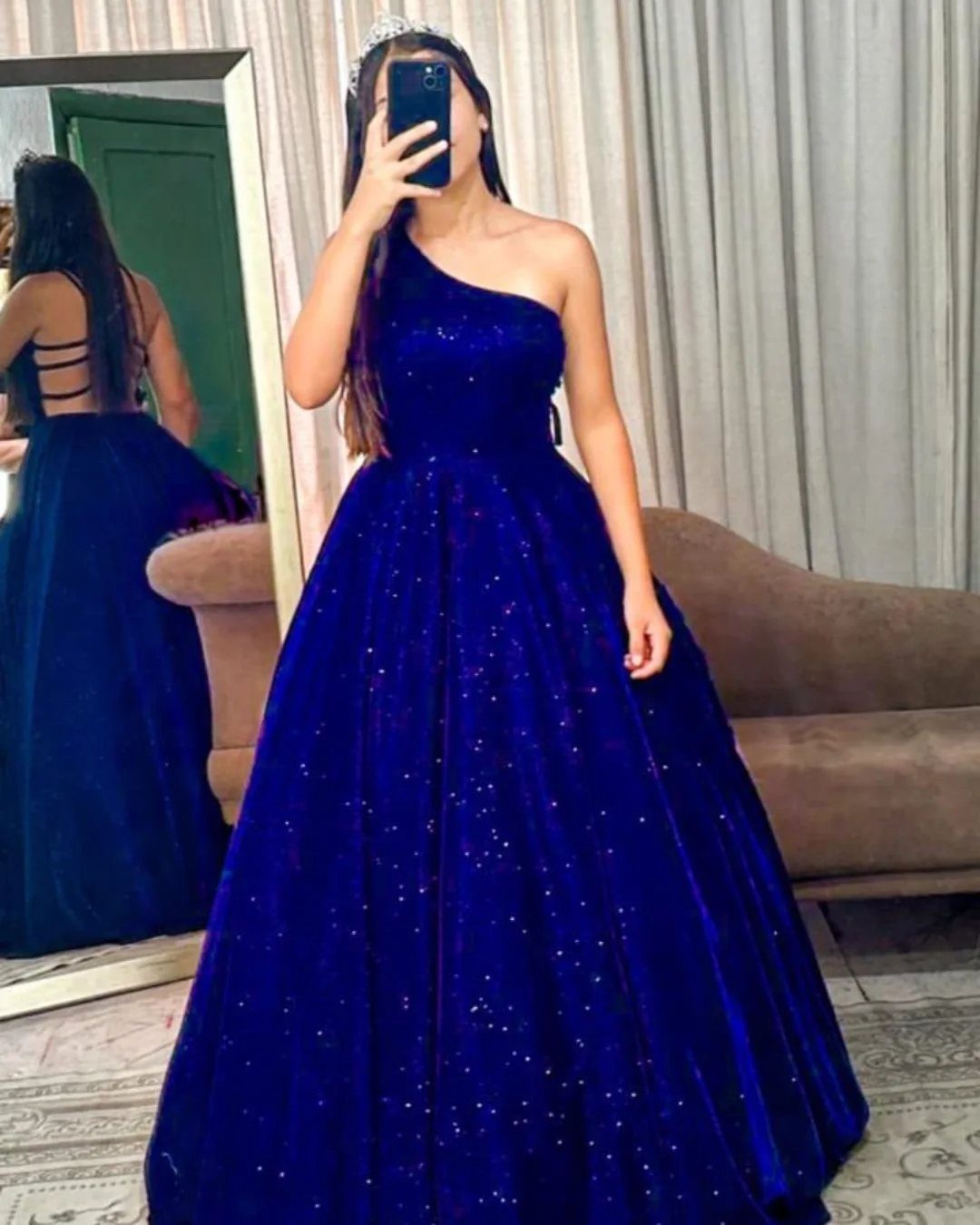 Ball Dresses Blue for Prom and Formal Events: 10 Ideas 9 Woman in a royal blue glittery one-shoulder ball gown wearing a tiara.