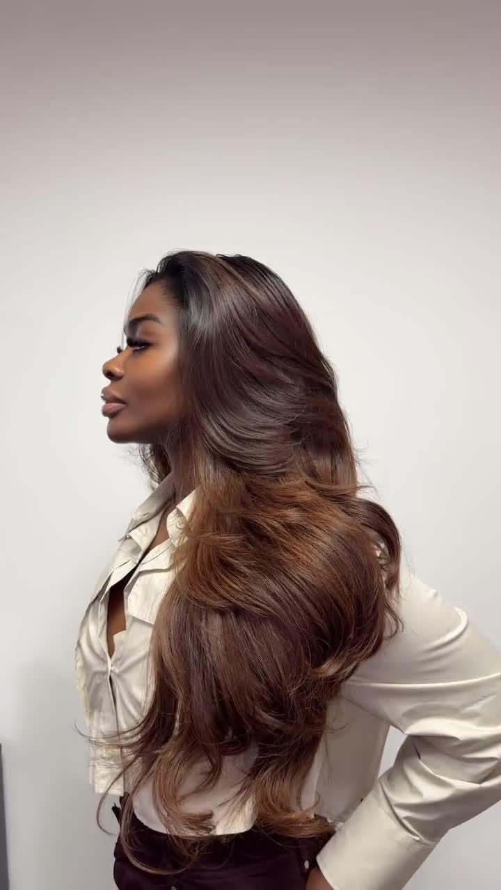 Best Hair Dye for Dark Hair: 8 Shades and Ideas 4 Woman with warm skin tones and long wavy brown hair with golden highlights.