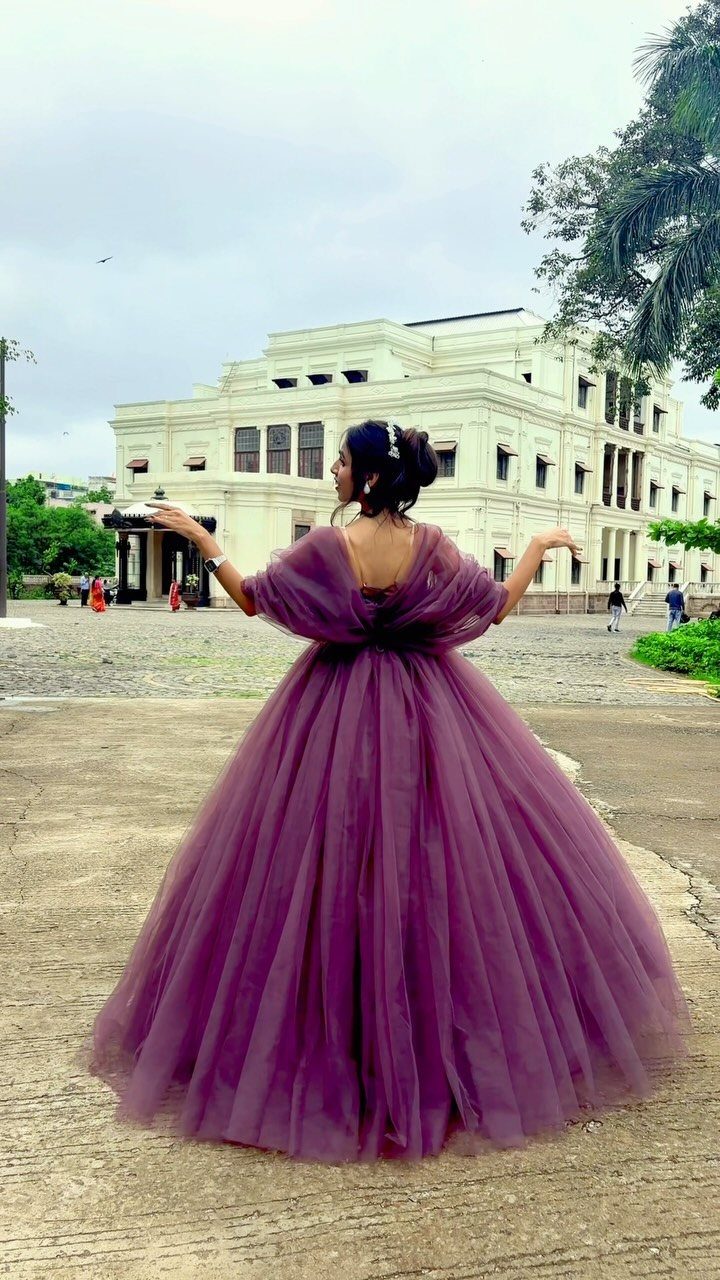 Big Princess Dress Ideas: 7 Tulle, Lace and Satin Gowns 6 Woman in a voluminous purple tulle gown standing before a white classical building.