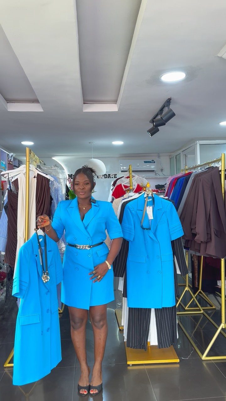 Blue Blazer Outfit for Women: 24 Ideas to Wear 3 Woman wearing a bright blue belted blazer dress in a clothing boutique.