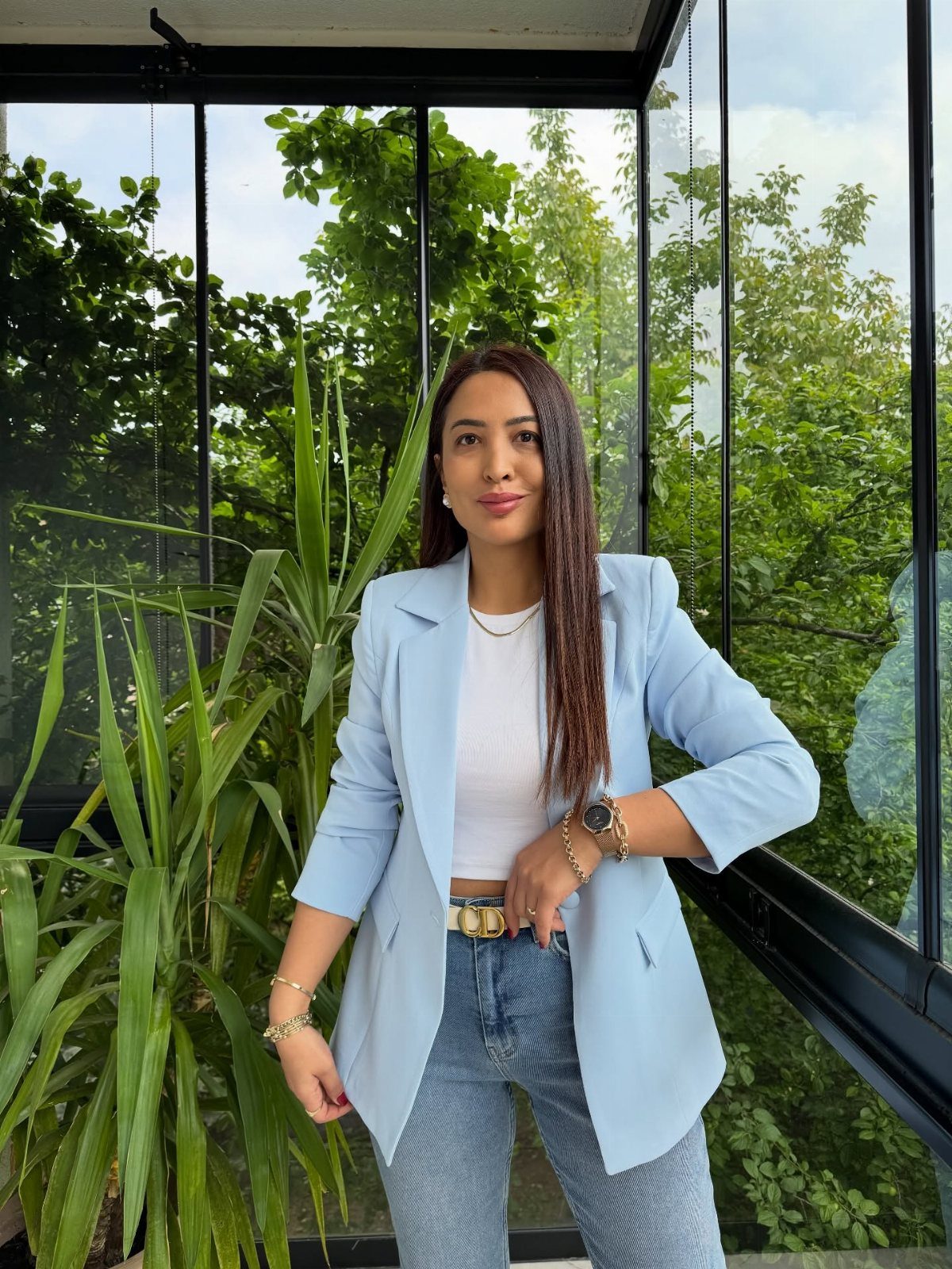 Blue Blazer Outfit for Women: 24 Ideas to Wear 12 Woman in light blue blazer, white tank top, and light blue jeans standing indoors.
