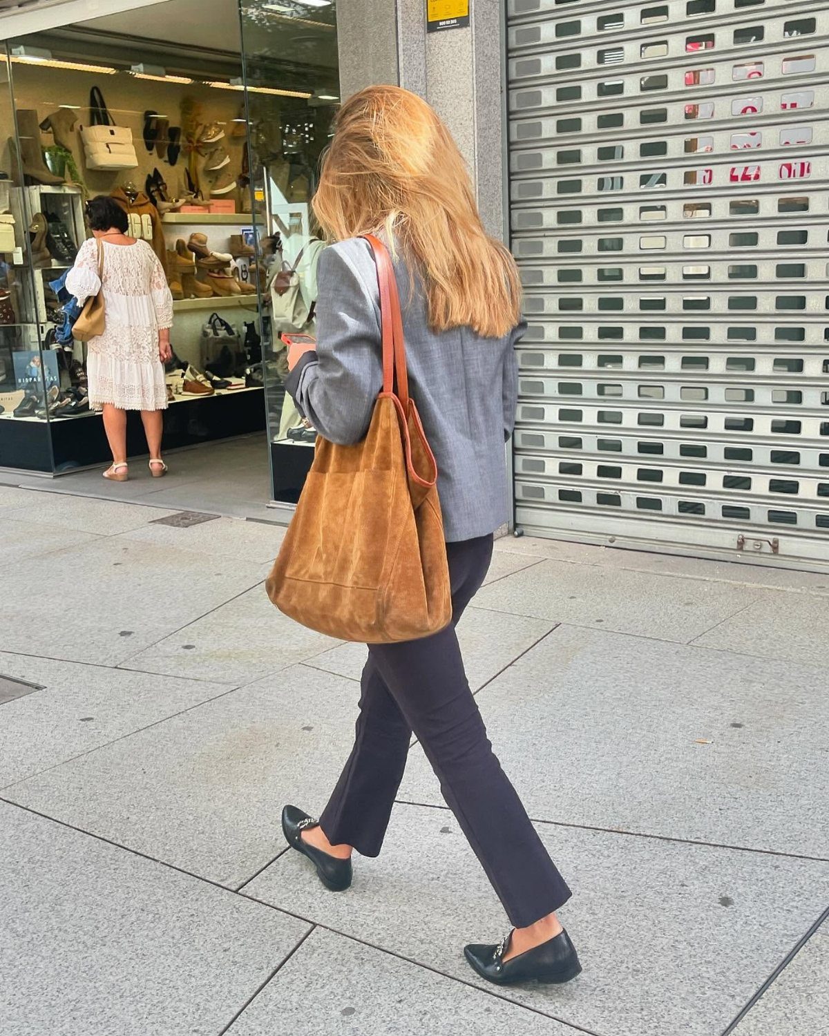 Blue Blazer Outfit for Women: 24 Ideas to Wear 7 Woman in blue blazer and black trousers carrying a cognac suede shoulder bag