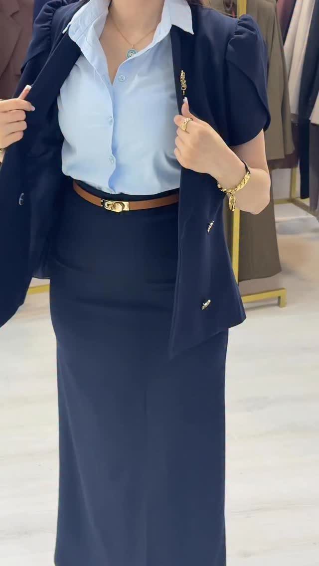 Blue Blazer Outfit for Women: 24 Ideas to Wear 18 Woman wearing a navy blue blazer, light blue shirt, and matching navy maxi skirt.