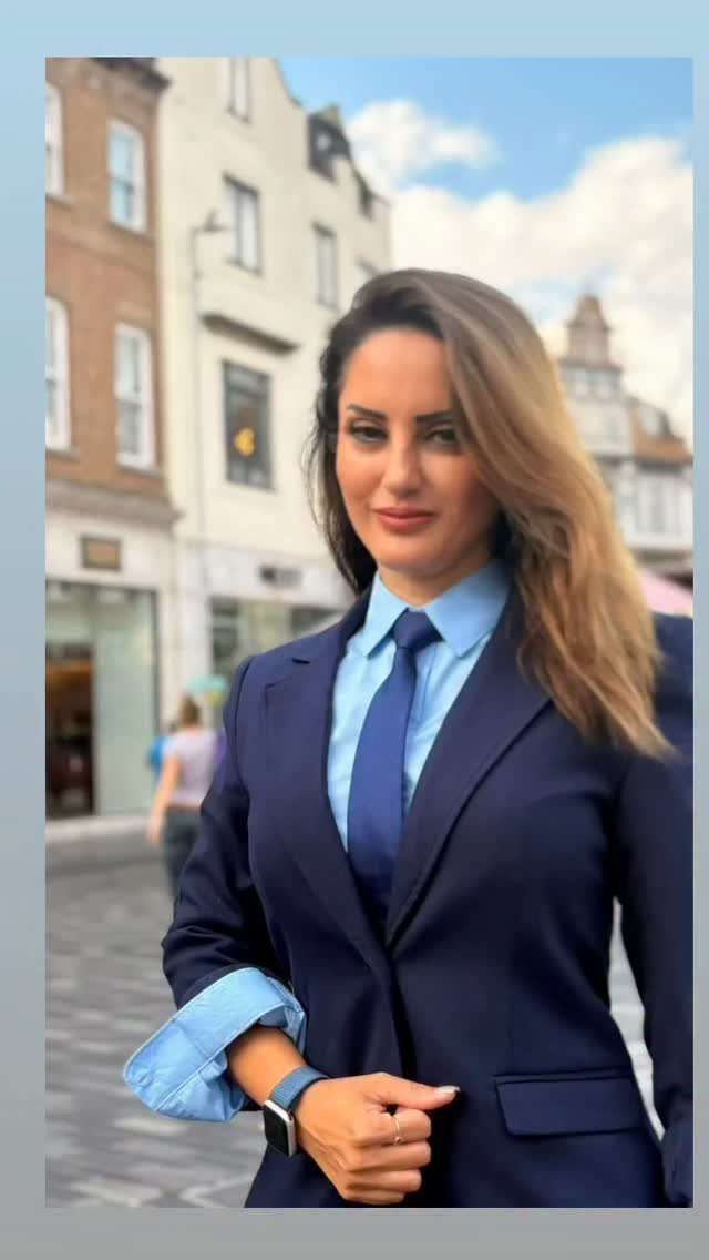 Blue Blazer Outfit for Women: 24 Ideas to Wear 21 Woman wearing a dark blue blazer, light blue shirt, and matching blue tie.