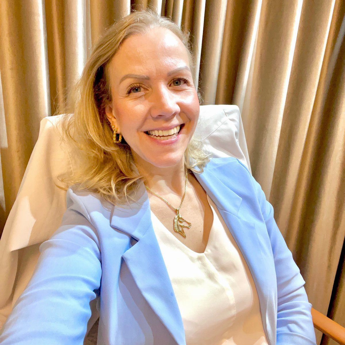 Blue Blazer Outfit for Women: 24 Ideas to Wear 11 Woman in light blue blazer and white top wearing a gold pendant necklace