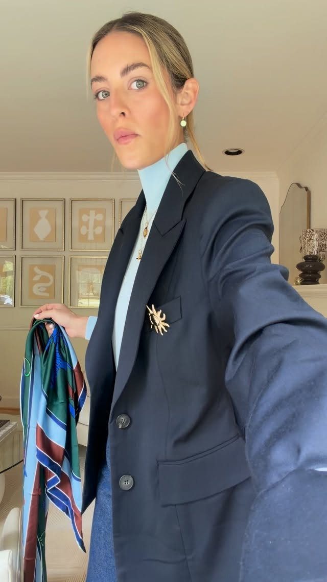 Blue Blazer Outfit for Women: 24 Ideas to Wear 24 Woman wearing a navy blue blazer and light blue turtleneck with a colorful scarf.