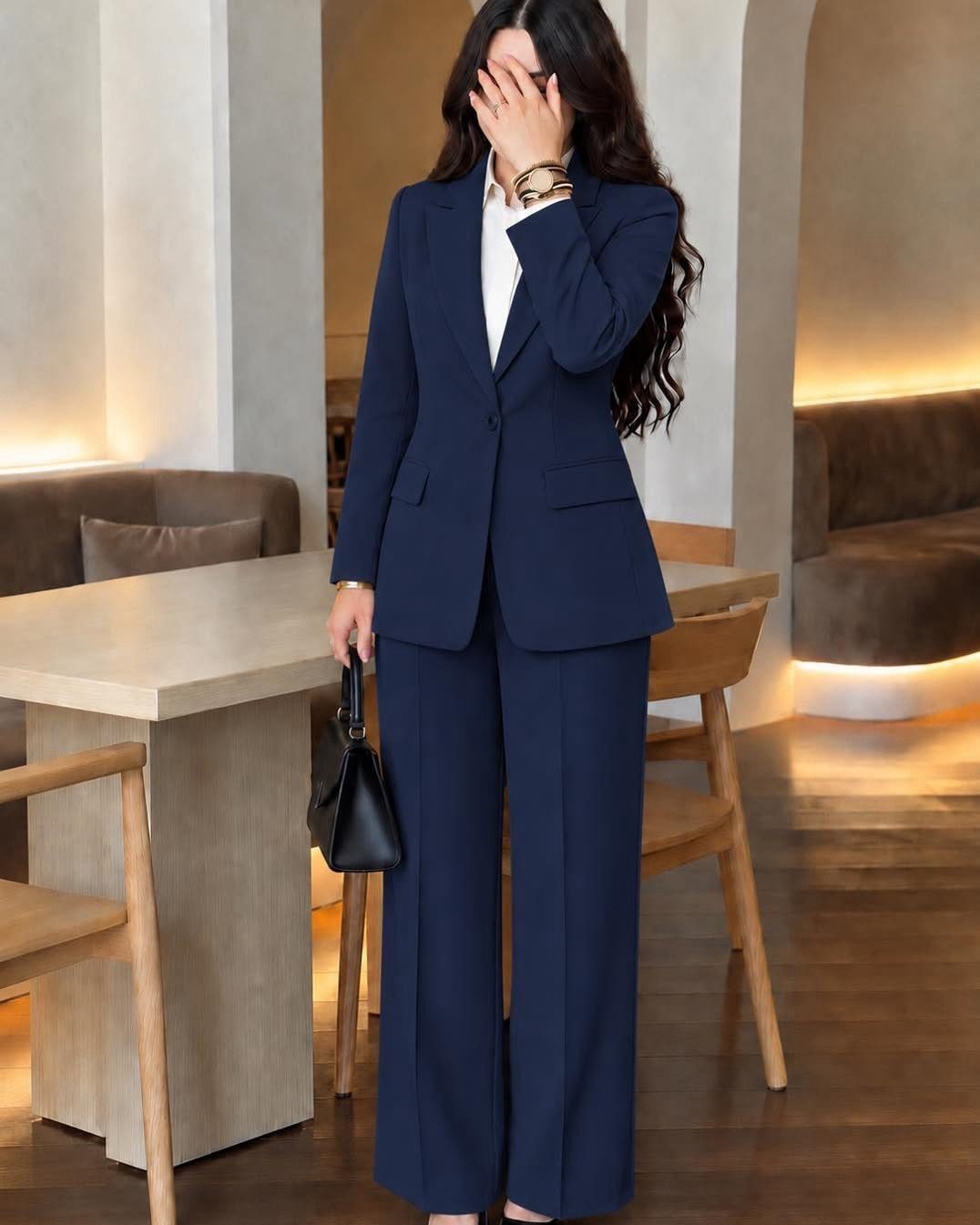 Blue Blazer Outfit for Women: 24 Ideas to Wear 5 Woman in navy blue blazer and wide-leg trousers with a white shirt and handbag.