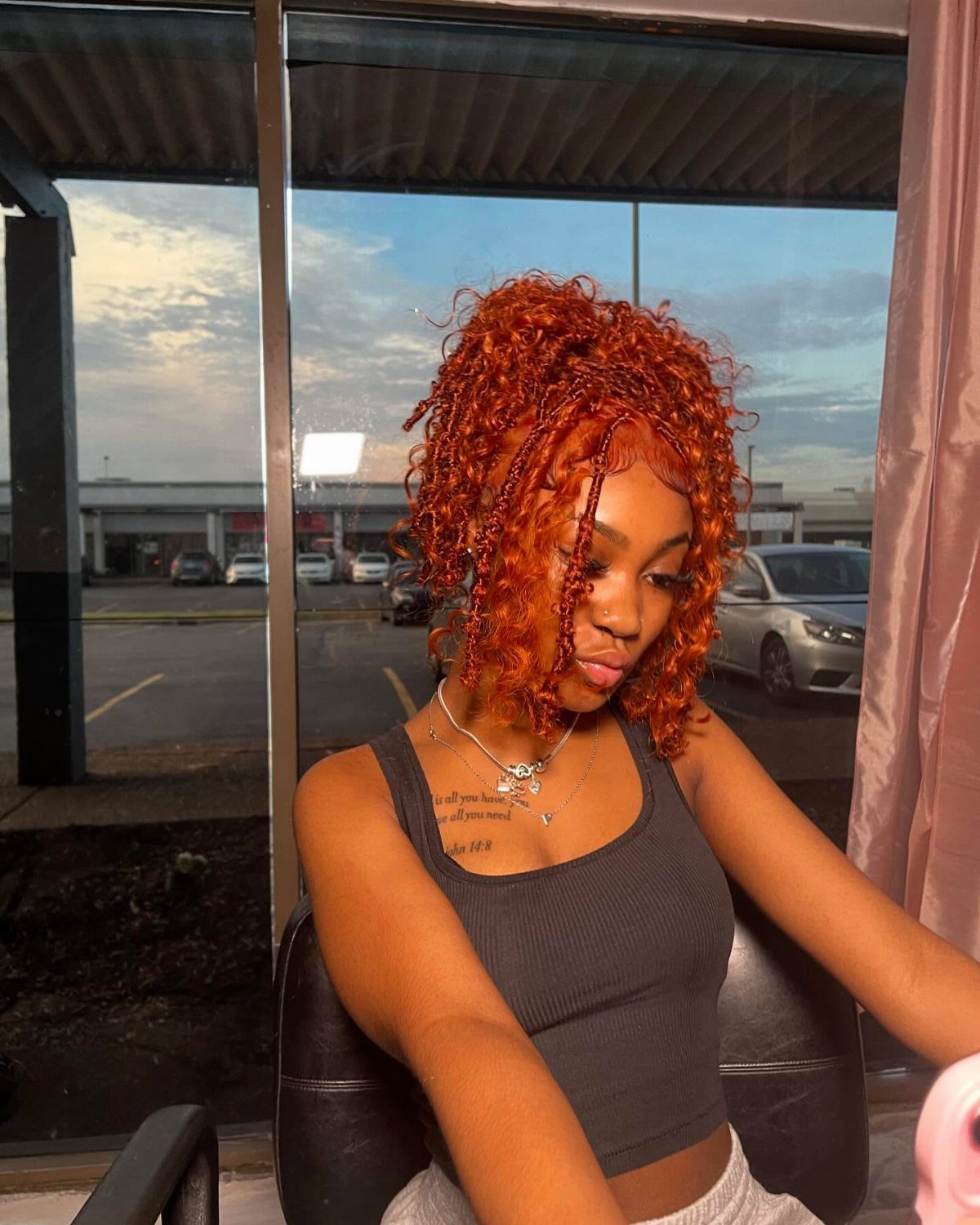 18 Bobo Hair Style Ideas, From Lob to Boxy Cuts 2 Woman with bright orange-red braided bob hairstyle wearing a grey crop top.