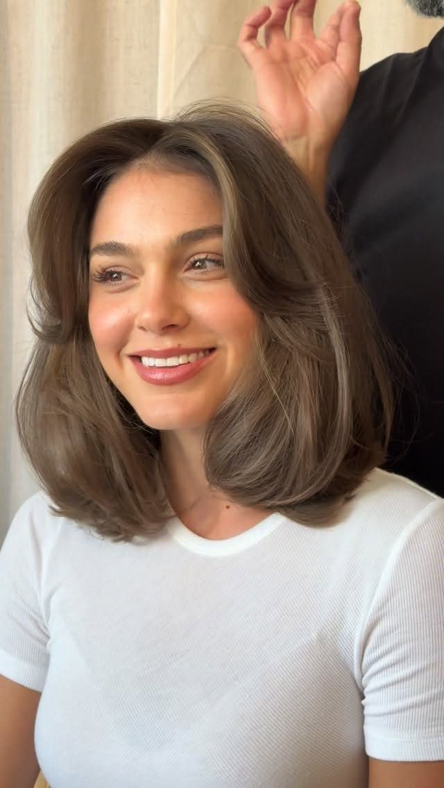 18 Bobo Hair Style Ideas, From Lob to Boxy Cuts 7 Woman with a voluminous, rounded brown bubble bob hairstyle and a white t-shirt.