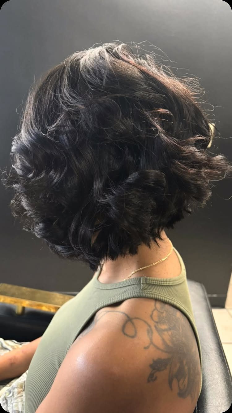 18 Bobo Hair Style Ideas, From Lob to Boxy Cuts 9 Curly dark brown bob haircut on a person with a shoulder tattoo.