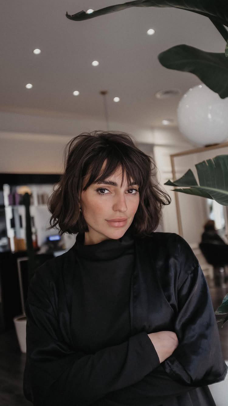 18 Bobo Hair Style Ideas, From Lob to Boxy Cuts 3 Woman with a chin-length textured brown French bob and soft fringe bangs.