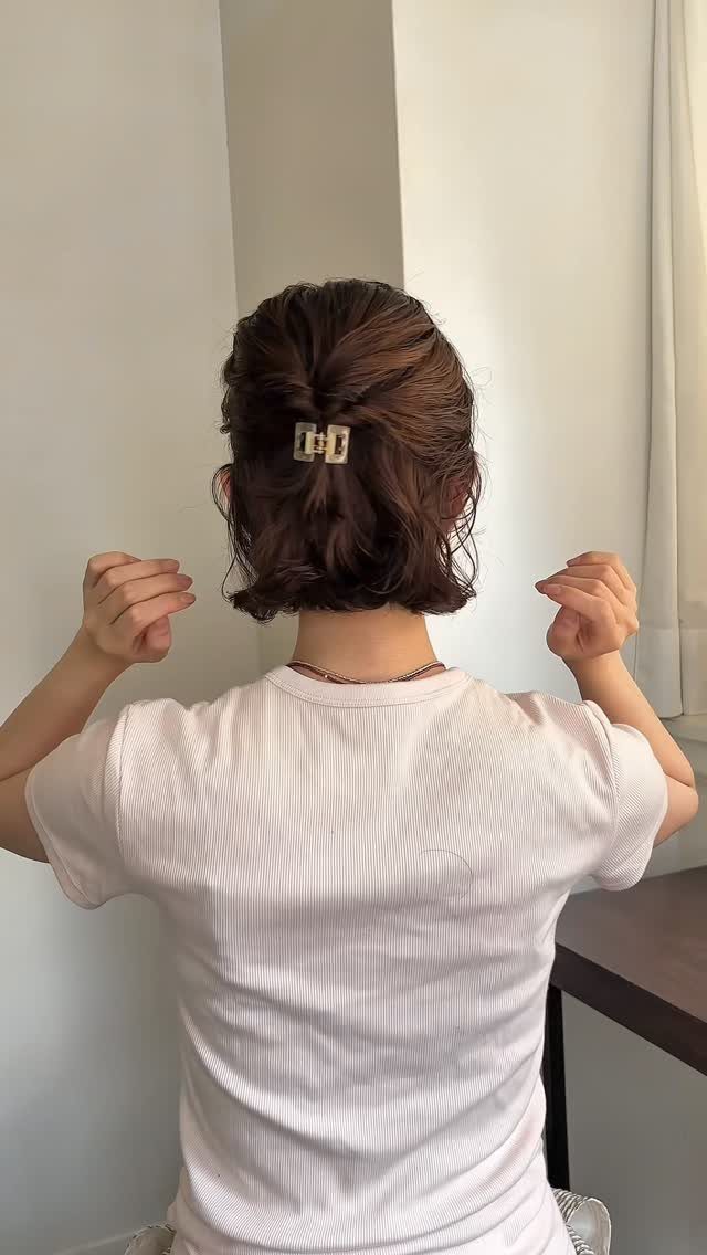 18 Bobo Hair Style Ideas, From Lob to Boxy Cuts 15 Brown bob haircut with the top half pulled back by a gold clip.