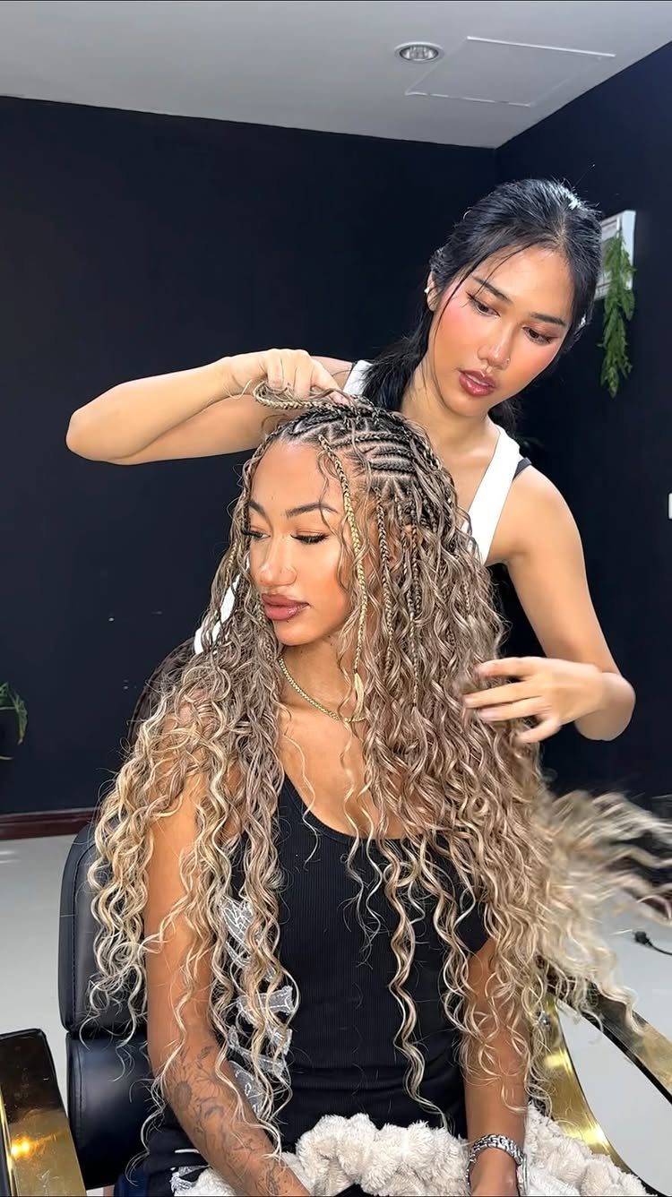 27 Boho Fulani Braids Hairstyles for Every Length and Look 25 Woman with long blonde curly Fulani braids being styled by a professional stylist.