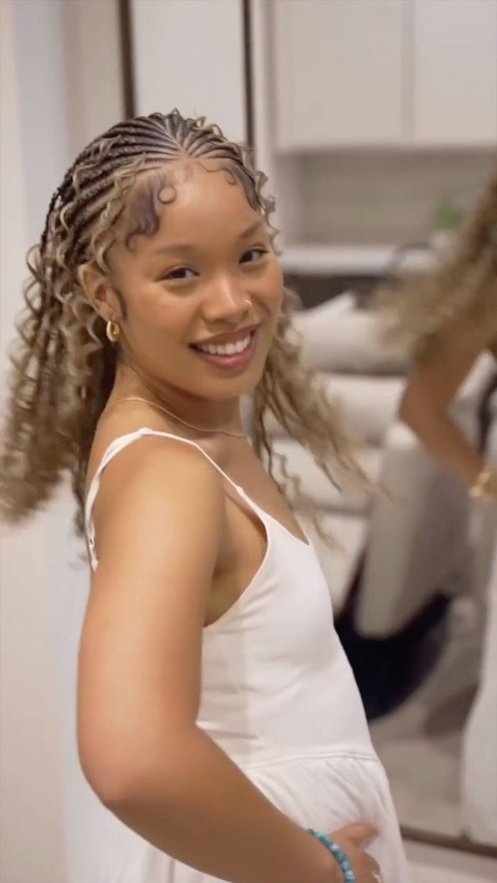 27 Boho Fulani Braids Hairstyles for Every Length and Look 27 Woman with medium-length Fulani braids and curly blonde ends wearing a white dress.