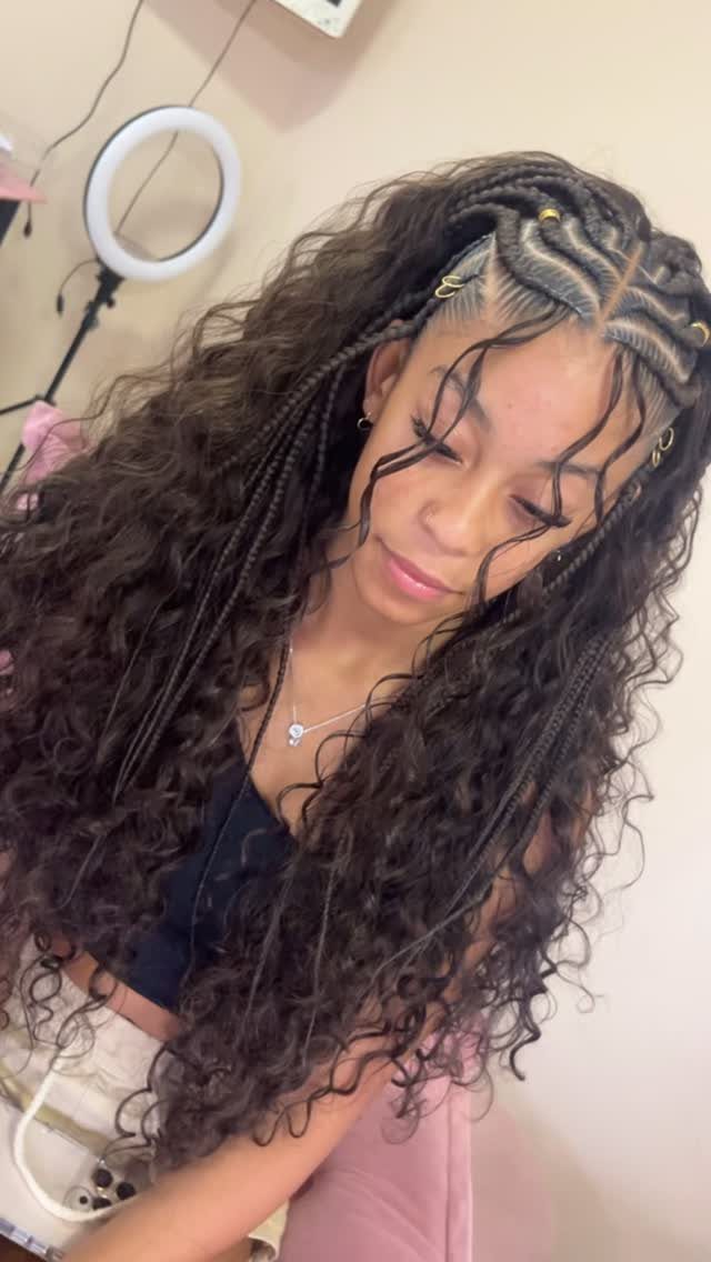 27 Boho Fulani Braids Hairstyles for Every Length and Look 26 Woman with long dark brown Fulani braids and curly extensions with gold beads