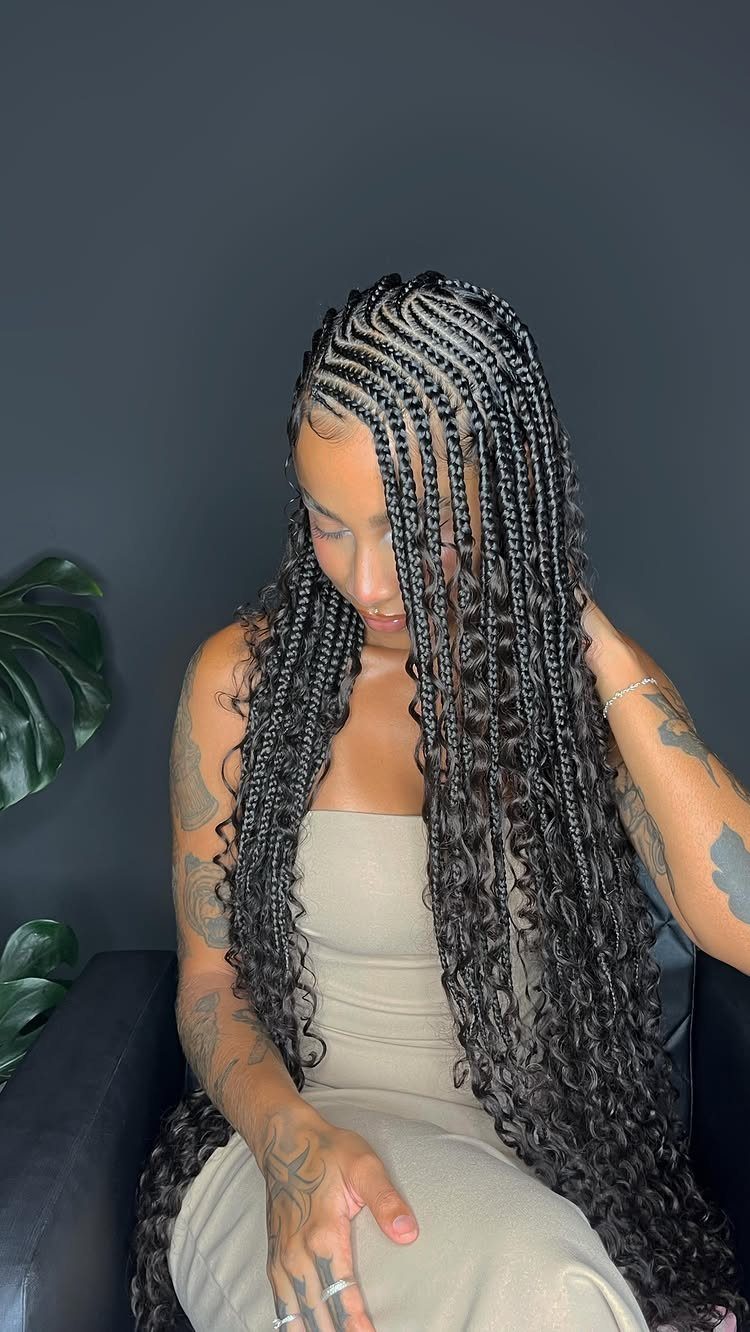 27 Boho Fulani Braids Hairstyles for Every Length and Look 4 Woman with long black Fulani braids and curly ends wearing a beige dress.
