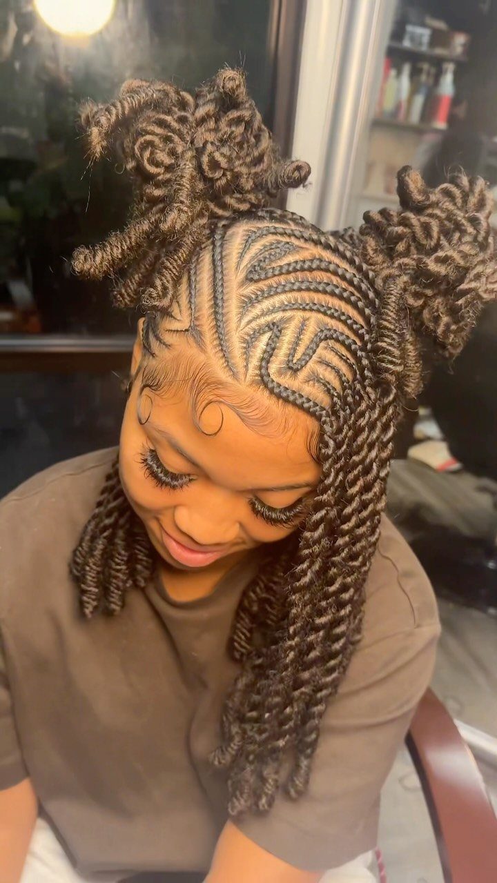 27 Boho Fulani Braids Hairstyles for Every Length and Look 15 Woman with cornrows transitioning into thick twists styled in two high buns.