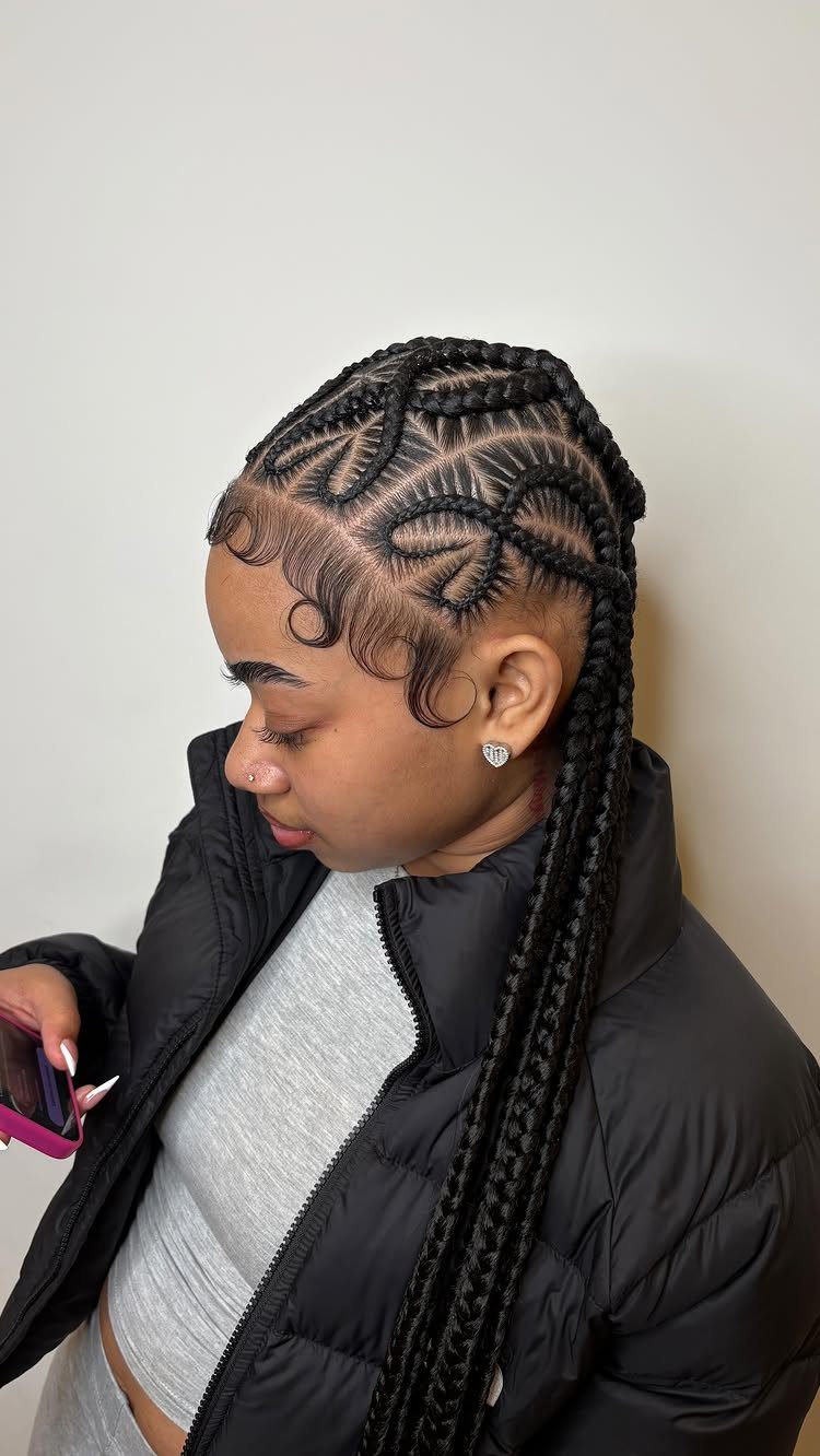 27 Boho Fulani Braids Hairstyles for Every Length and Look 21 Woman with black Fulani braids featuring a heart-shaped design on the side.