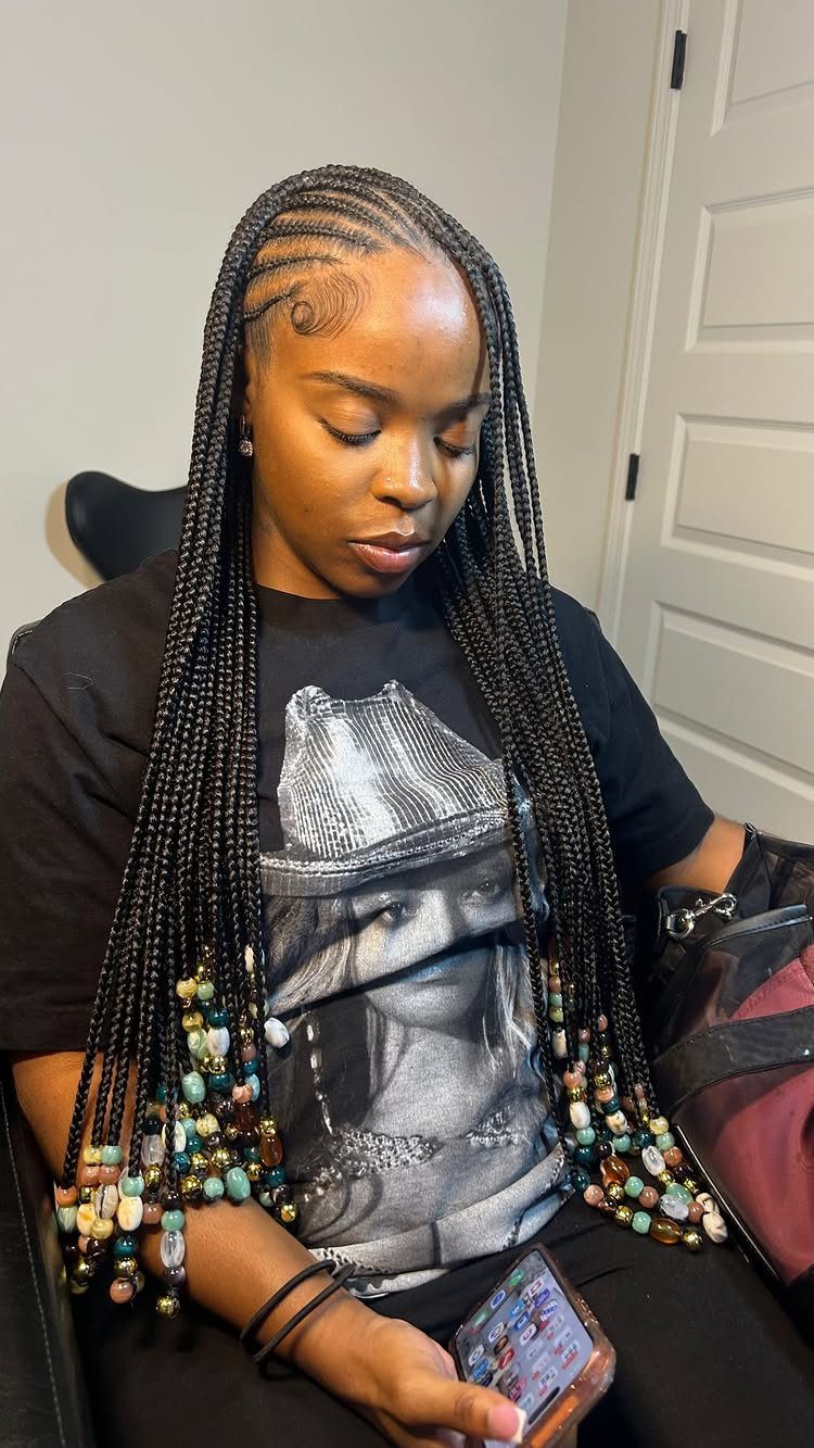 27 Boho Fulani Braids Hairstyles for Every Length and Look 7 Woman with medium length black Fulani braids decorated with colorful beads at ends