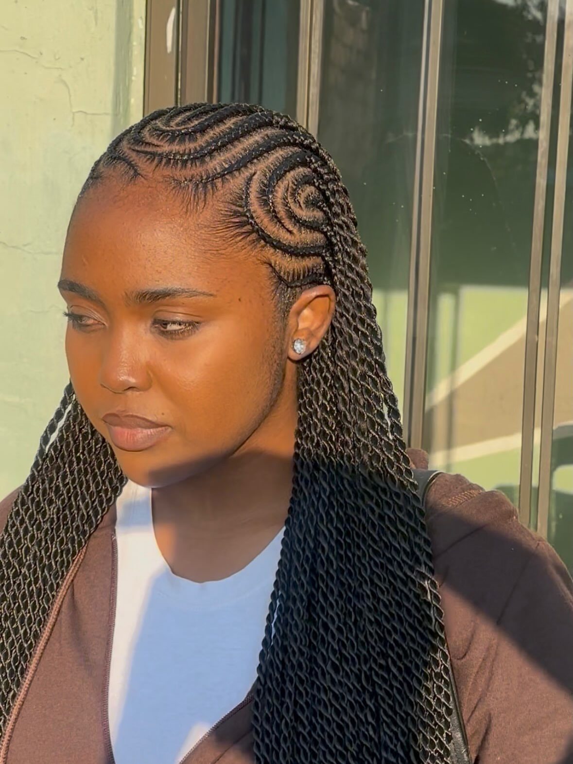 27 Boho Fulani Braids Hairstyles for Every Length and Look 10 Woman with black Fulani braids styled in intricate zig-zag patterns on her scalp.
