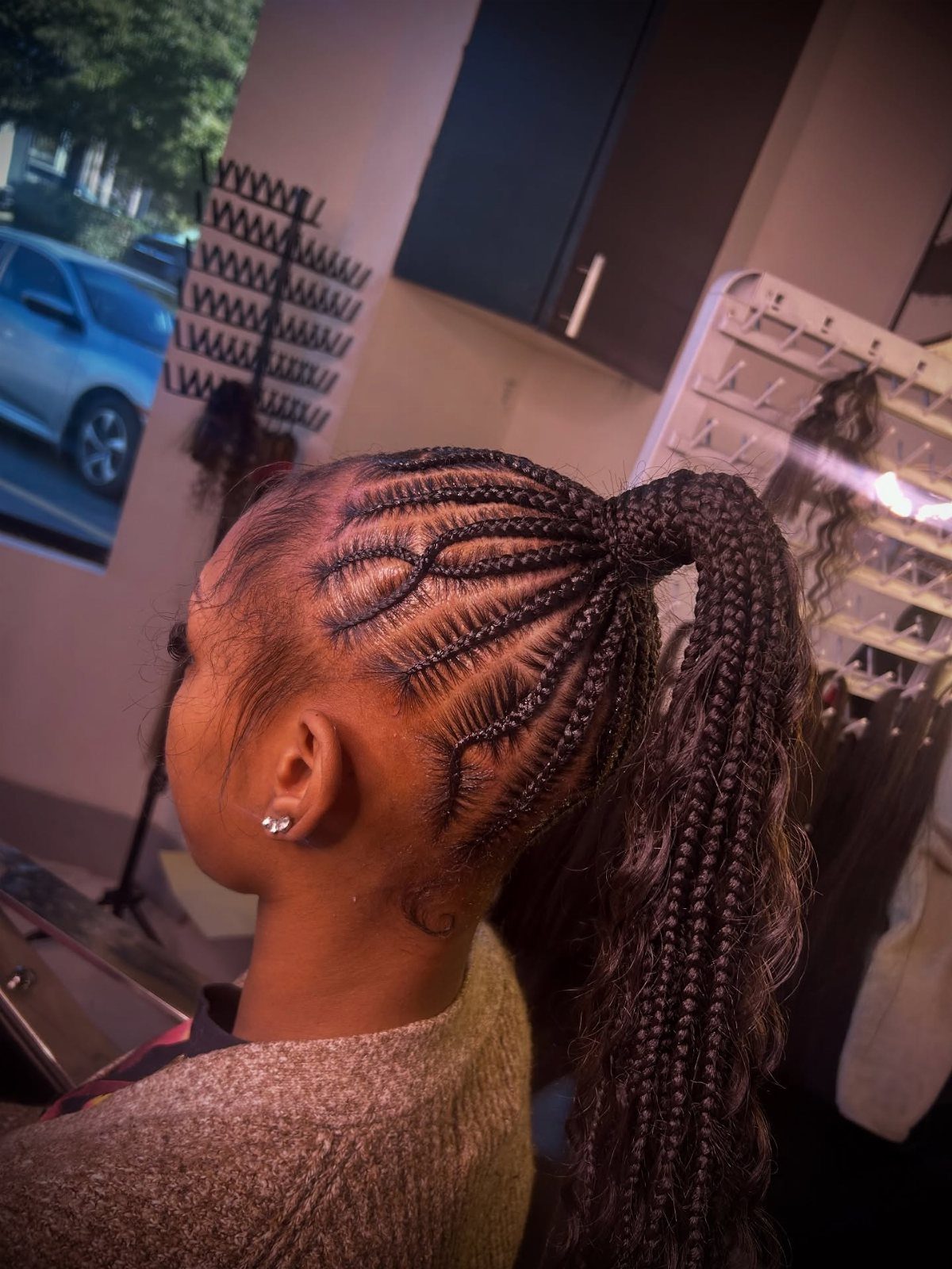 20 Braids and Women Hairstyles to Try in 2026 4 Woman with cornrows gathered into a long, thick braided ponytail from the side.