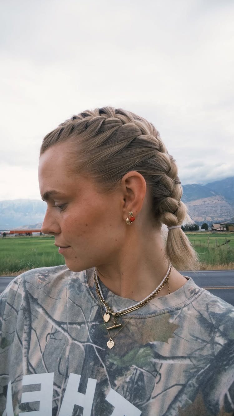 20 Braids and Women Hairstyles to Try in 2026 11 Woman with blonde hair styled in two thick French braids and a ponytail.