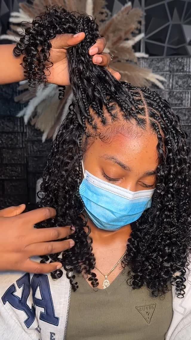 20 Braids and Women Hairstyles to Try in 2026 17 Woman with long curly goddess braids and cornrows wearing a blue face mask