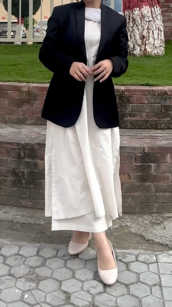 Casual Court Outfit for Women: 6 Ideas to Wear 4 Woman wearing a white maxi dress with a black blazer and beige flats.