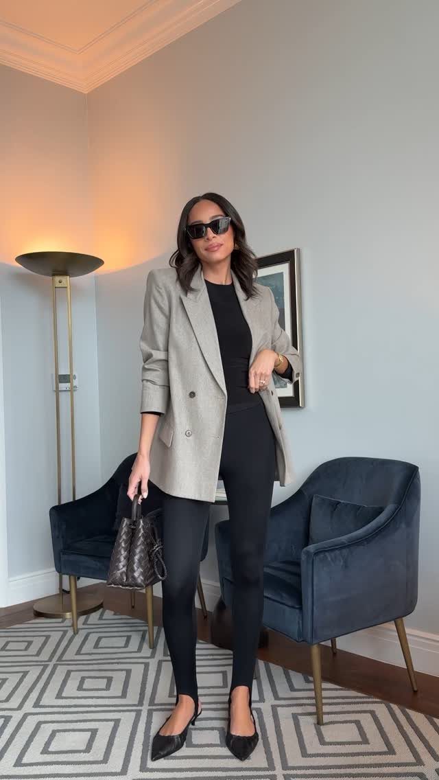 12 Casual Elegance Outfits for Easy Everyday Style 6 Woman wearing a grey blazer, black top, and black leggings with pointed flats.