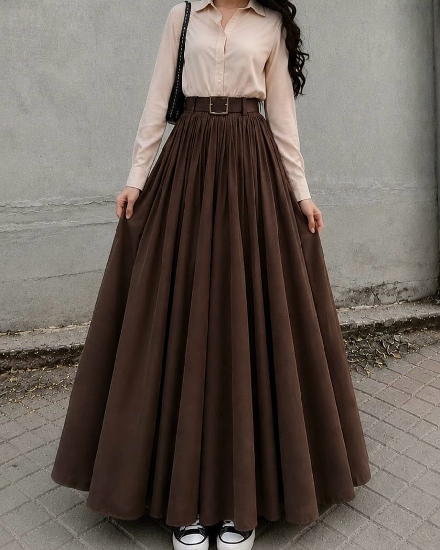 12 Casual Elegance Outfits for Easy Everyday Style 7 Person wearing a beige button-down shirt and a brown pleated maxi skirt.