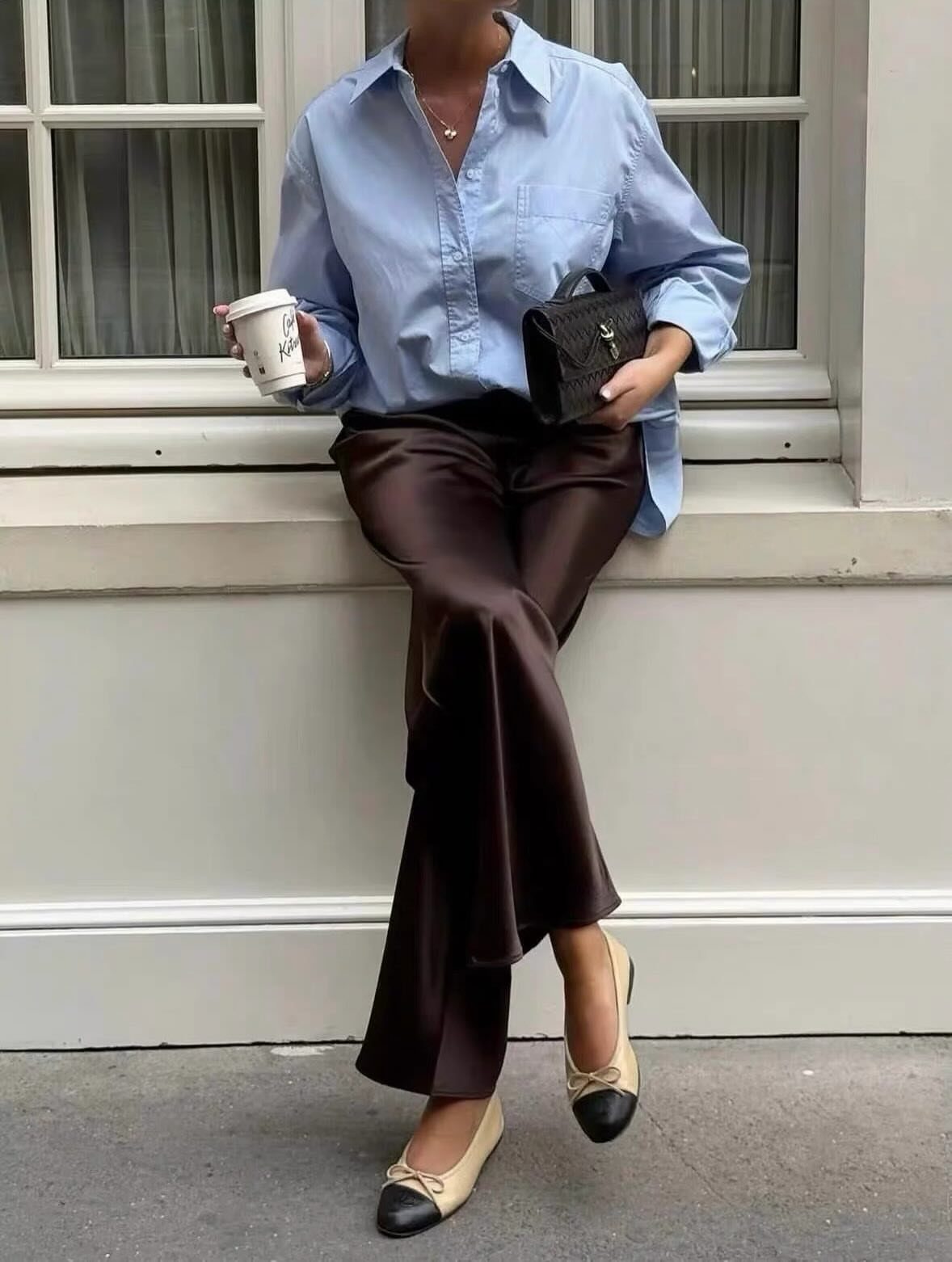 12 Casual Elegance Outfits for Easy Everyday Style 11 Person wearing a blue shirt, brown satin trousers, and beige ballet flats.