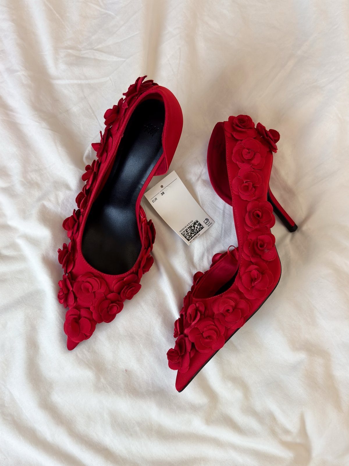 Cherry Red Kitten Heels: 6 Ideas from Straps to Buckles 4 Cherry red kitten heels with 3D fabric roses on a white cloth background