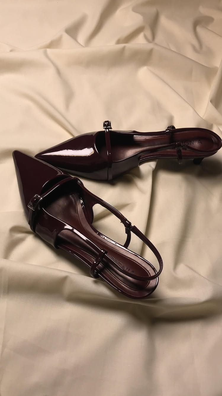 Cherry Red Kitten Heels: 6 Ideas from Straps to Buckles 3 Dark cherry red patent leather kitten heels on draped cream fabric.