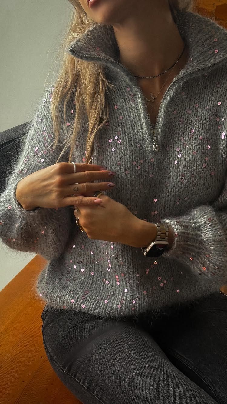Christmas Outfit for Work: 13 Ideas to Wear to the Office 9 Woman wearing a grey sequined fuzzy knit sweater with a zipper neckline.