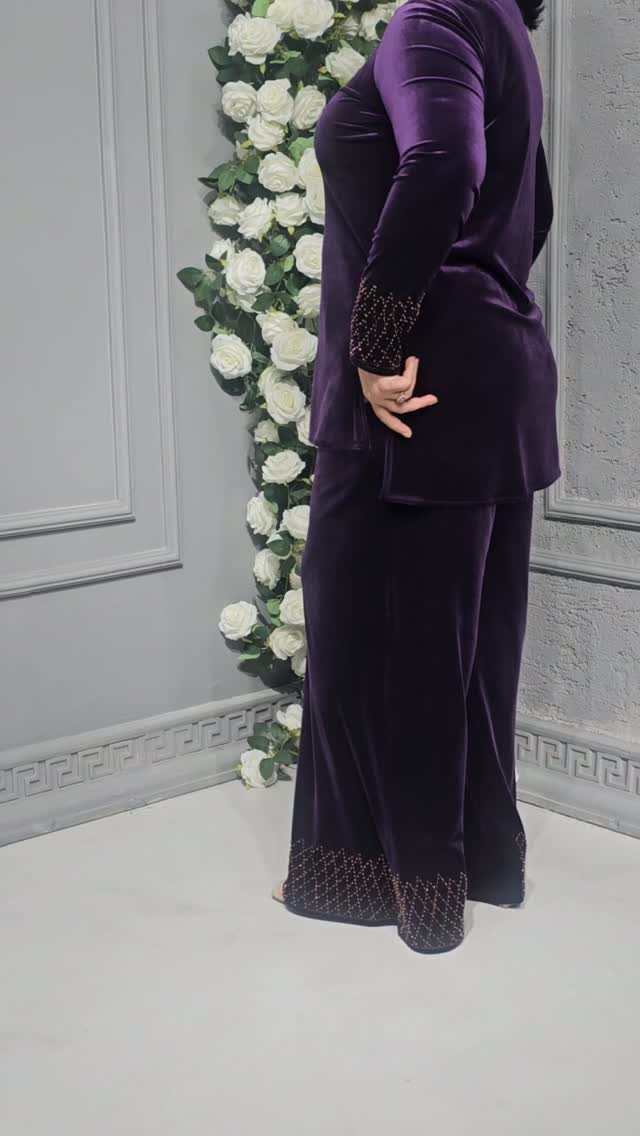 Christmas Outfit for Work: 13 Ideas to Wear to the Office 11 Person in a purple velvet suit standing next to white roses against grey wall