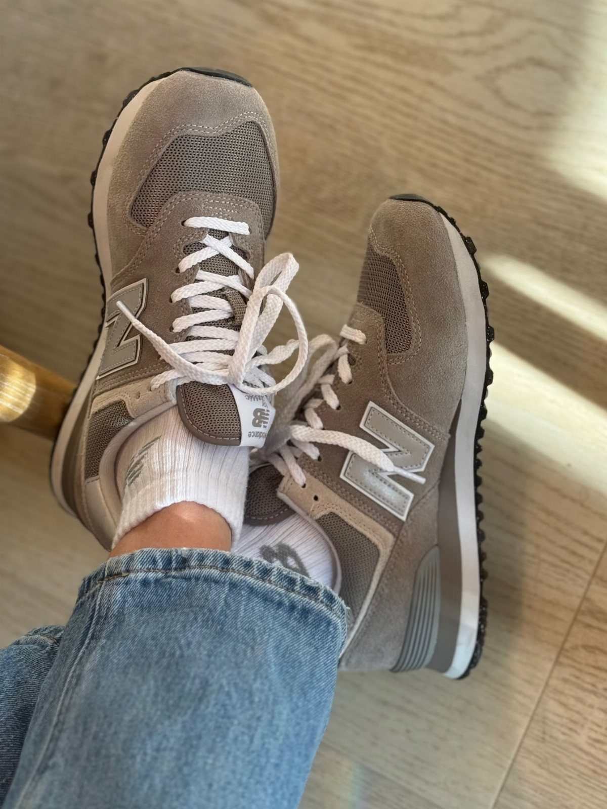 5 Chunky Shoes and New Balance Sneakers Worth Wearing 4 Grey New Balance 574 sneakers with white laces and blue denim jeans.