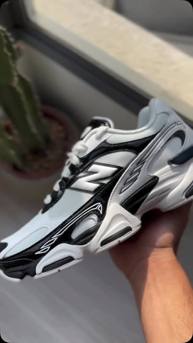 5 Chunky Shoes and New Balance Sneakers Worth Wearing 1 White and black New Balance 9060 chunky sneakers held in a person's hand.