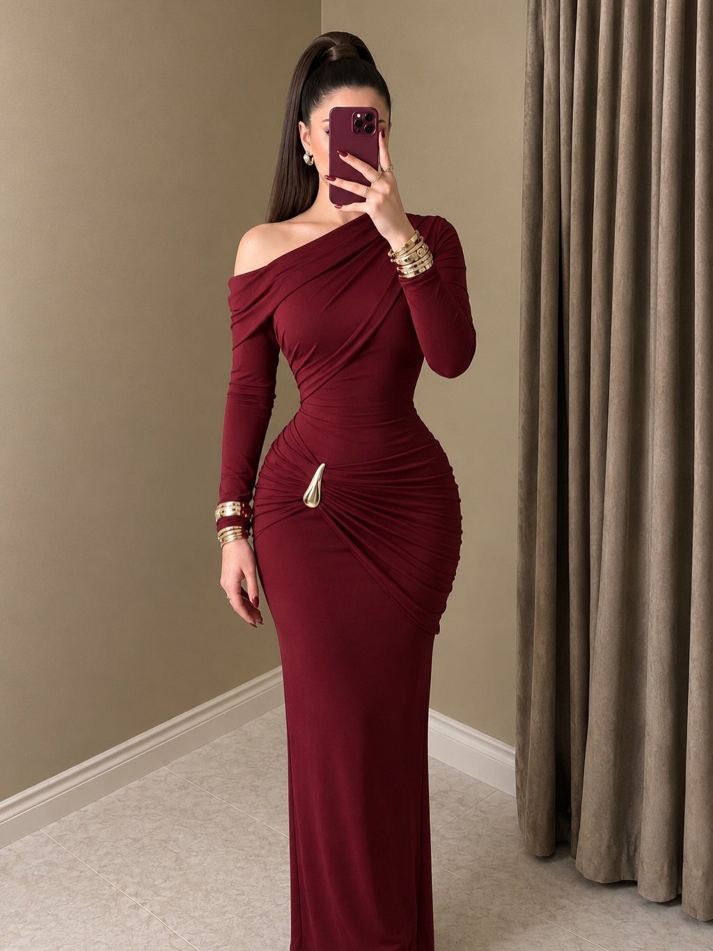 Classic Formal Gowns: 8 Styles for Evening Events 6 Woman in a long-sleeved burgundy floor-length gown with one-shoulder neckline and gold accessories.