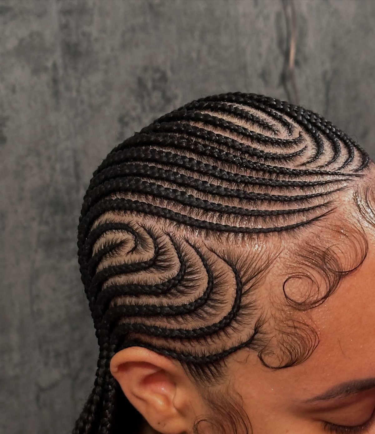 Cornrows and Twists Hairstyles: 11 Ideas to Try 5 Intricate black cornrow braids styled in curved patterns on a person's head.