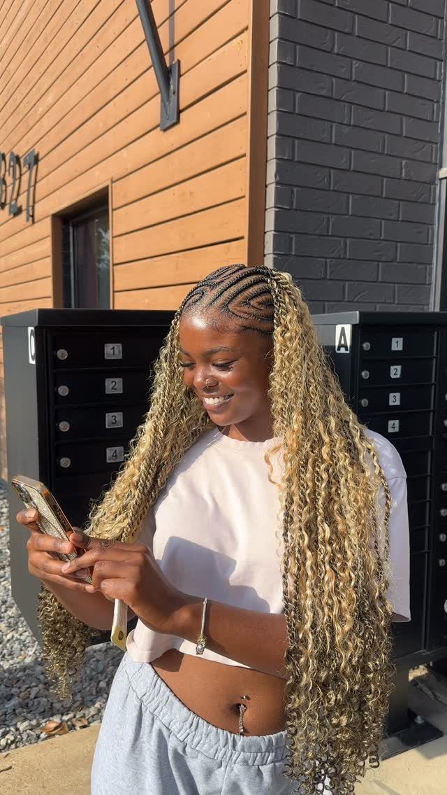 Cornrows and Twists Hairstyles: 11 Ideas to Try 10 Woman with long blonde and brown cornrow braids and twists looking at phone.