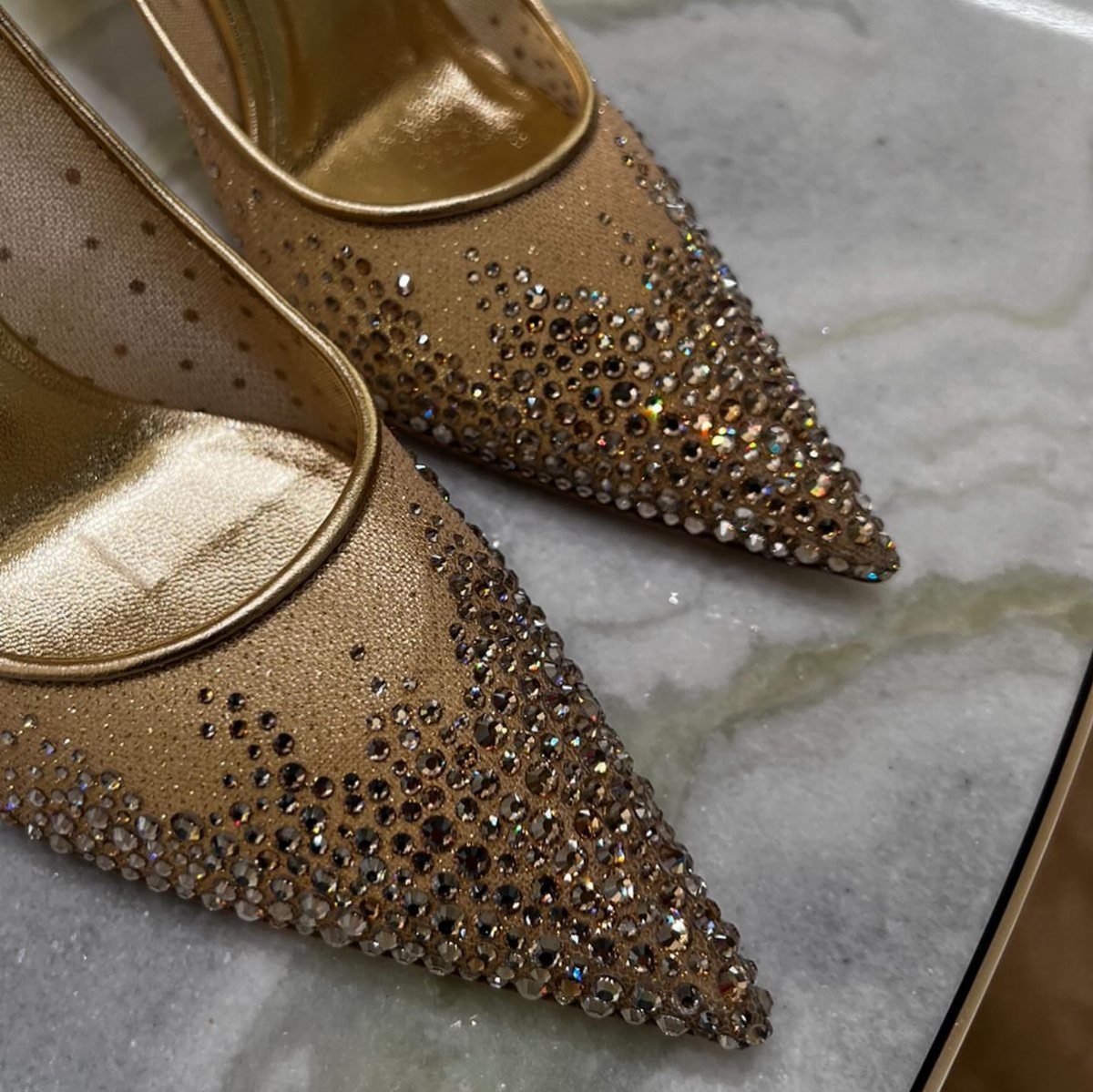 Crystal Embellished Heels: 5 Ideas for Brides and Beyond 3 Gold pointed-toe high heels with sparkling crystal embellishments on a marble surface